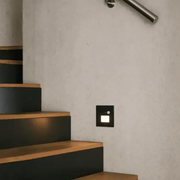 Step light with sensor in black installed on the wall.